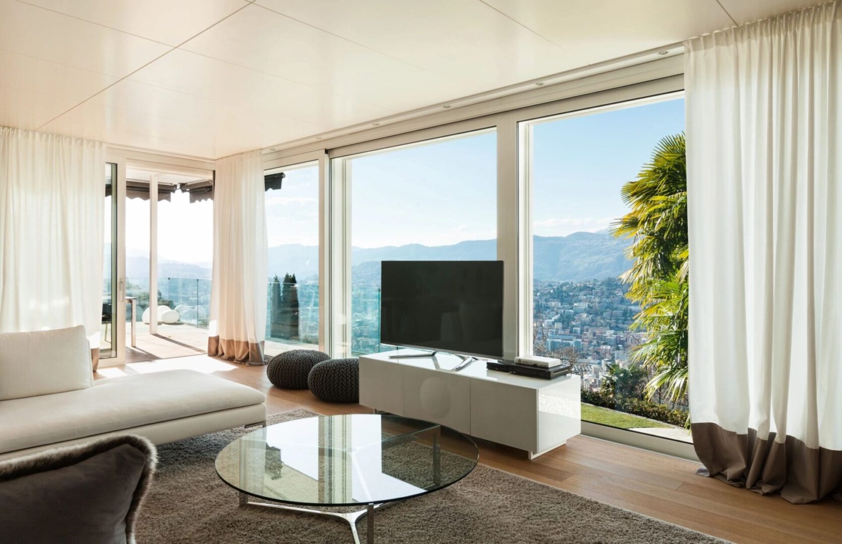 qtq80-vJQFTZ A living room with large windows and a view of the mountains.